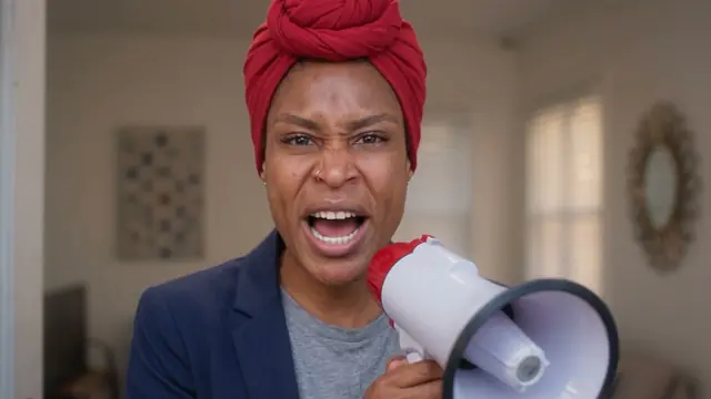 Marie-Claude shouting into a megaphone